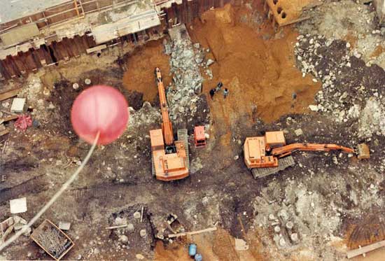 Red marker balloon fluttering from the tower crane on Gutter Lane, three of the archaeologists can be seen far below on Terra Firma