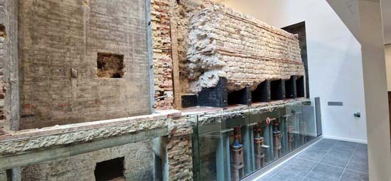 The inner face of the Roman city wall and modern support structures in the new display at ‘City Wall at Vine Street’ museum